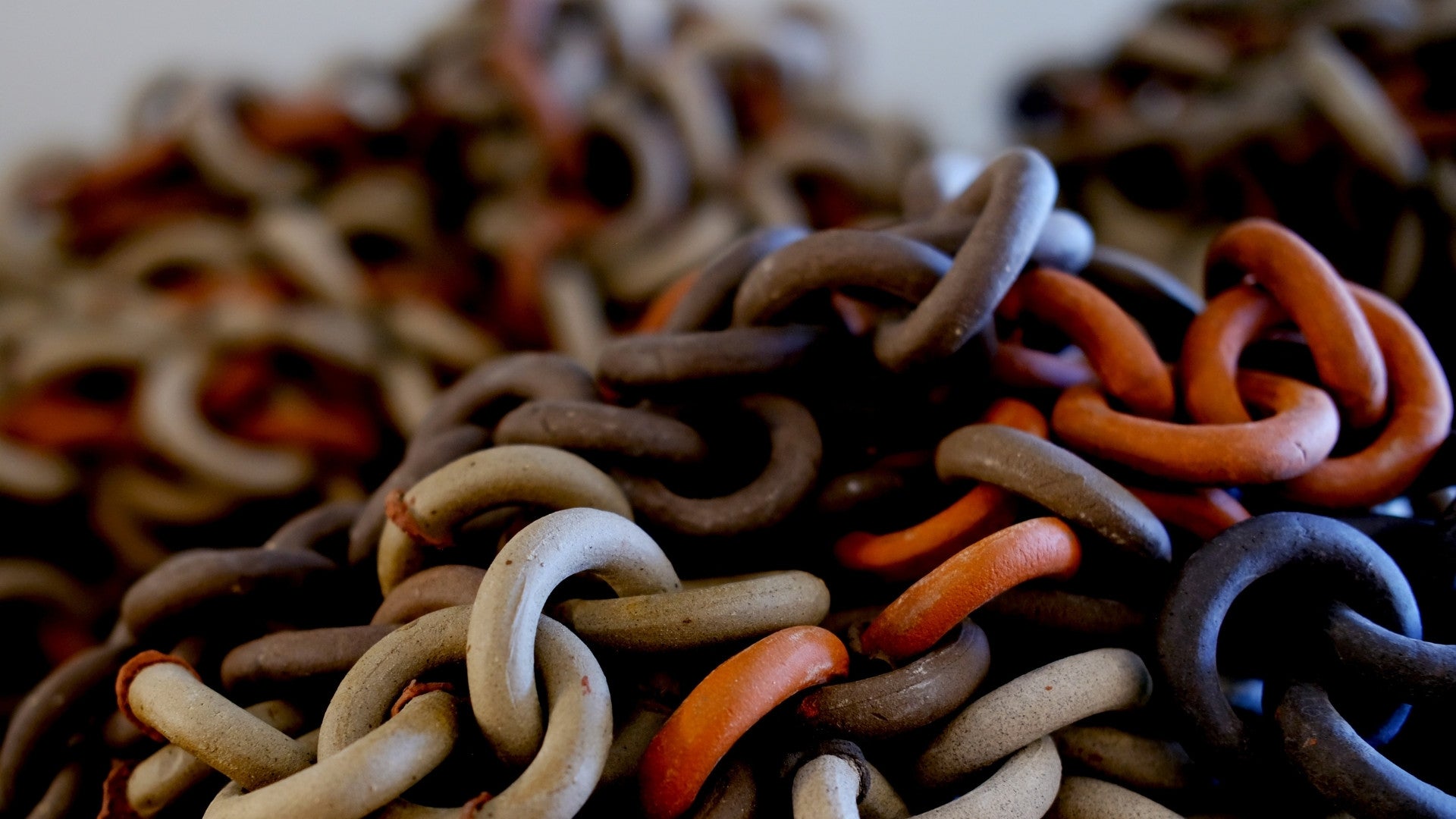 Close-up of colourful ceramic rings on a white background